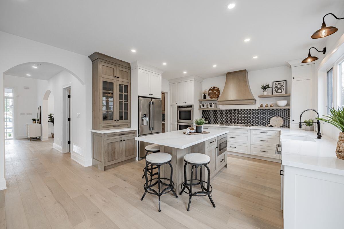 A spacious, light-filled kitchen featuring a central island, stainless steel appliances, and elegant cabinetry in Ontario | Ever After Homes